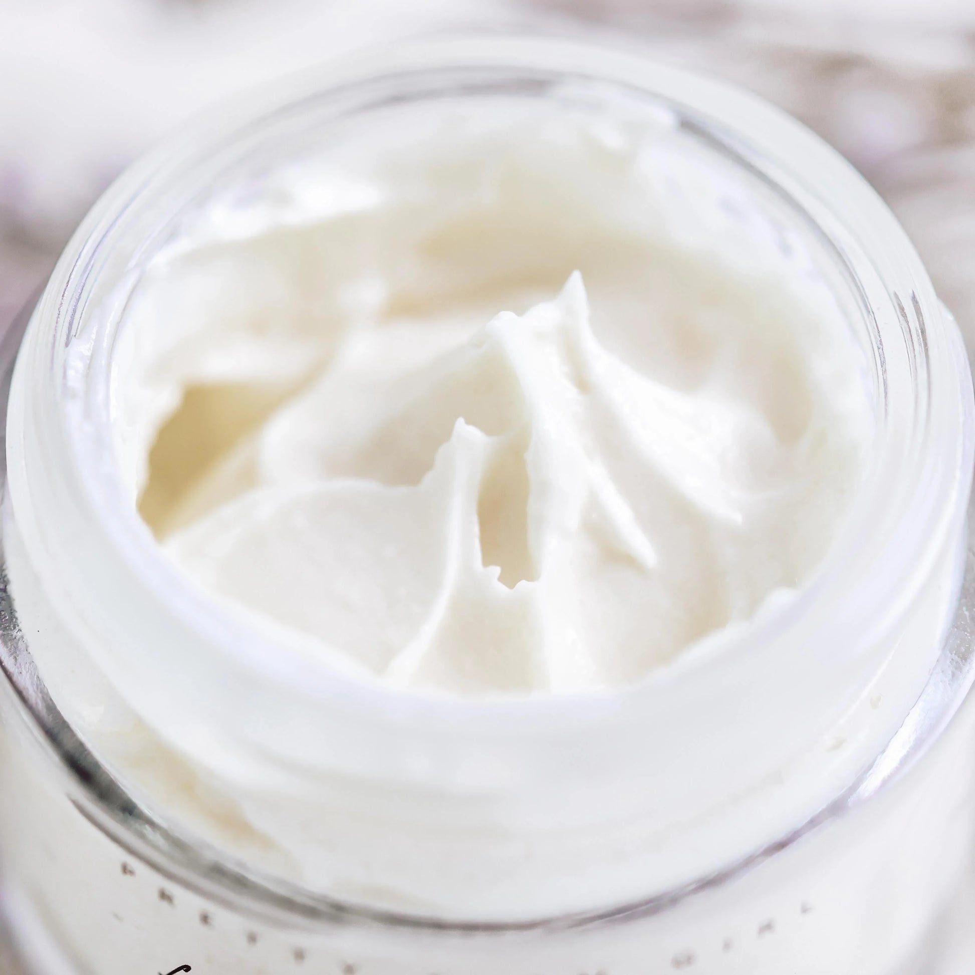 Rich white face cream in clear jar, smooth moisturizer for glowing skin