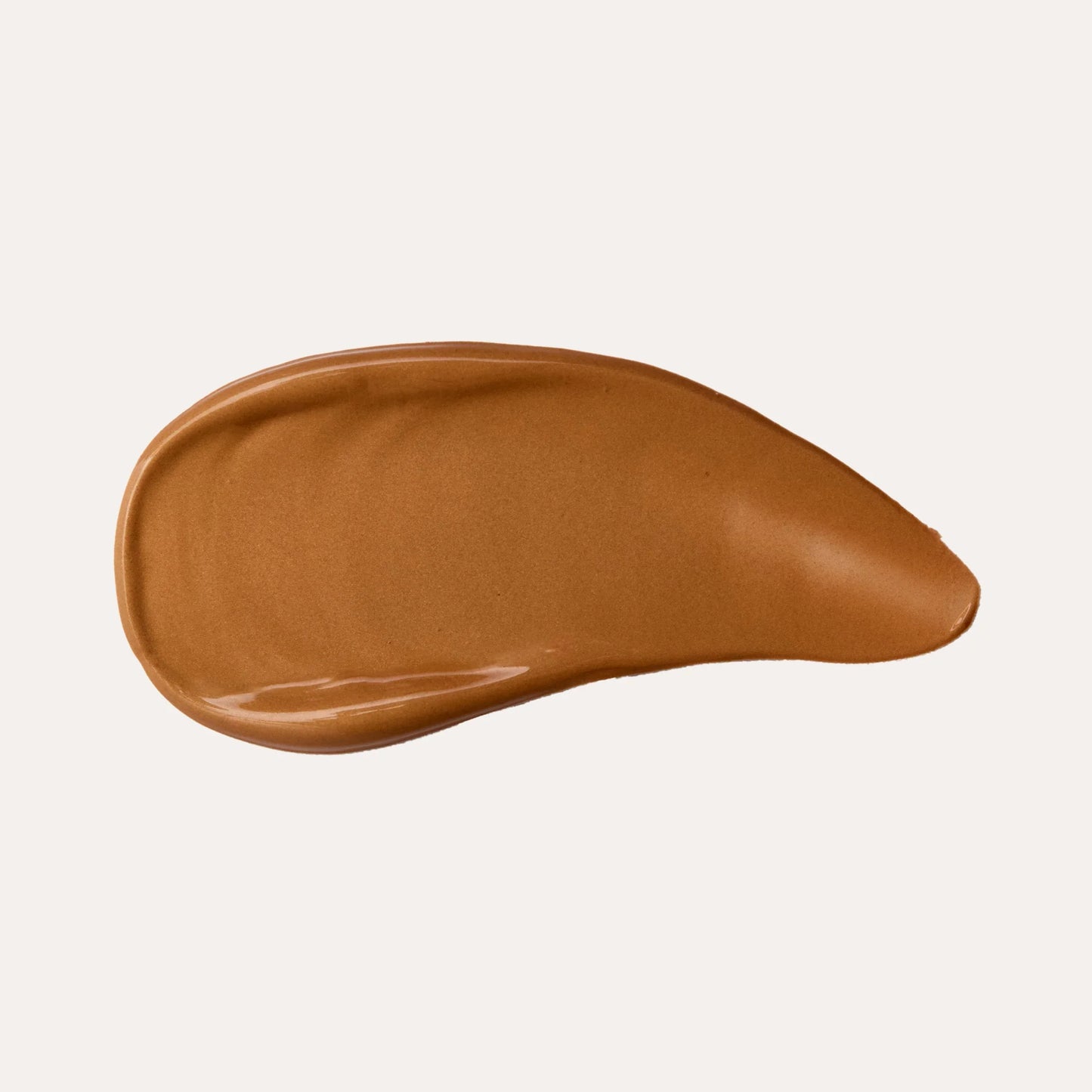 Rich brown liquid foundation swatch with smooth, creamy texture on neutral background